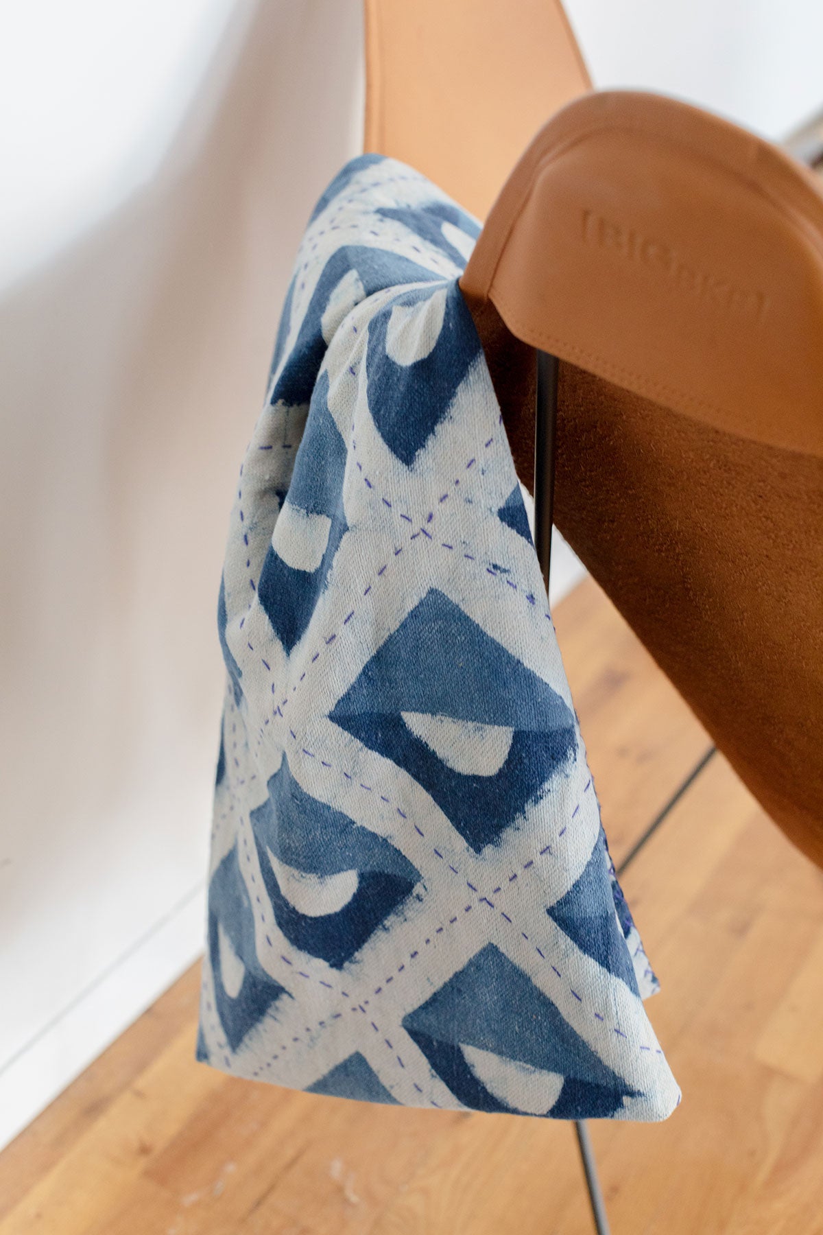 Blue and white hand block printed indigo throw featuring geometric shapes. Lightweight and easy to take with you to the beach or park, or to cuddle up with at home. 