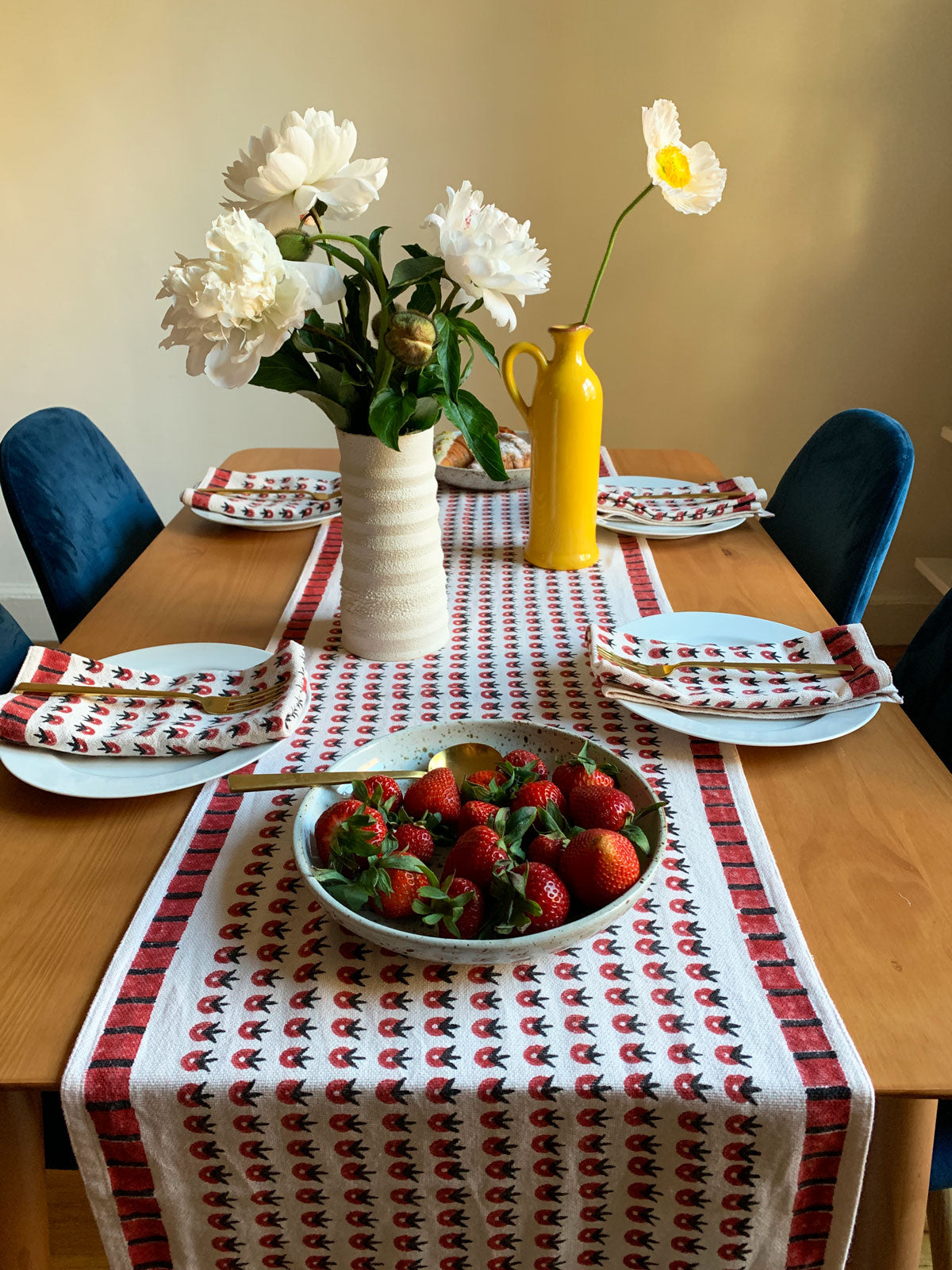 SUNDAY/MONDAY's hand block printed POPPY table runner and cloth napkins, featuring a summery red floral inspired pattern. Perfect for cozy, summer inspired brunches. 